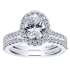Round brilliant diamonds climb their way up this white gold or platinum band to form a diamond halo surrounding an oval cut diamond of your choice in this diamond oval halo engagement ring! - Image 5 of 0