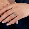 An 18k white gold eternity engagement ring with contemporary and modern styling, shining with nearly 1 full carat in round brilliant diamonds. - Image 3 of 0