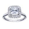 A double row of diamonds encapsulates a princess cut center diamond in this variation of a contemporary halo engagement ring. - Image 1 of 0