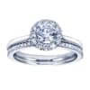 A round brilliant halo contrasts perfectly with the sleek white gold band in this contemporary halo engagement ring available in platinum or white gold. - Image 5 of 0