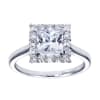 A stylish white gold or platinum band meets a round brilliant diamond halo holding a princess cut center diamond in this contemporary halo engagement ring. - Image 1 of 0