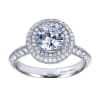 This white gold engagement ring has double rows of round diamonds to accent a round center diamond in this contemporary halo engagement ring. - Image 1 of 0