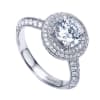 This white gold engagement ring has double rows of round diamonds to accent a round center diamond in this contemporary halo engagement ring. - Image 4 of 0