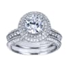 This white gold engagement ring has double rows of round diamonds to accent a round center diamond in this contemporary halo engagement ring. - Image 5 of 0