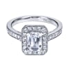 An emerald cut center diamond gleams magnificently encircled in round brilliant diamonds set in a vintage halo engagement ring designed by Gabriel & Co. - Image 2 of 0