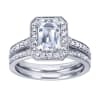 An emerald cut center diamond gleams magnificently encircled in round brilliant diamonds set in a vintage halo engagement ring designed by Gabriel & Co. - Image 5 of 0