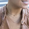 0.10 carats of round brilliant diamonds in a bar and bezel setting necklace. - Image 2 of 0