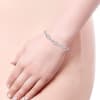 This 14k white gold diamond link tennis bracelet boasts over 1.5 carats of diamonds set into alternating white gold oval and bar sections. - Image 3 of 0