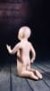 Fleshtone fiberglass toddler mannequin in a kneeling pose with realistic facial features for countertop retail display. - Image 2 of 0