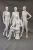 Seated matte white female fiberglass mannequin with left leg crossed sitting on a white stool base. - Image 5 of 0