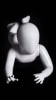 Glossy white toddler mannequin with abstract egghead in a belly-down laying pose for retail display. - Image 1 of 0