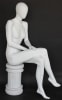 Female egghead mannequin in seated pose. Her legs are crossed with her hands on her lap. - Image 2 of 0
