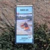 Barker Lake Whitewater Area satellite paper canoe map featuring classified rapids, portage paths, and campsites in a protective plastic sleeve. - Image 1 of 0