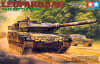 Dramatic box art illustration of WW2 German main battle tank, Leopard 2 A6 rolling down a dirt road through a forest with sand trailing behind it. - Image 1 of 0
