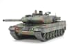 Dramatic box art illustration of WW2 German main battle tank, Leopard 2 A6 rolling down a dirt road through a forest with sand trailing behind it. - Image 2 of 0