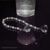 Diamond pearl tassel around 4" vase, being held with silver swirl hook - Image 1 of 0
