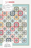 Glam Squad Quilt Pattern from Lella Boutique shows a scrap quilt of multi-colored star blocks each with a unique frame around them. - Image 1 of 0