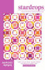 This allover quilt design features stars and hourglass shapes in shades of red, pink and yellow on a white background. - Image 1 of 0