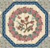 Abingdon Quilt Pattern by Michelle Yeo shows a quilt with an appliqued center, surrounded by pieced blocks. - Image 2 of 0