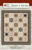 Bread & Butter  Quilt Pattern by Nancy Rink Designs shows a quilt with blocks set on-point for a dramatic effect and with a dark floral border. - Image 1 of 0