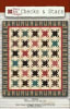 Checks & Stars Quilt Pattern from Nancy Rink Designs shows a scrappy quilt with straight set blocks set with tiny neutral colored nine patch blocks in-between. - Image 1 of 0
