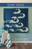 Surf Wave Quilt Pattern by Robin Pickens shows a modern, graphic quilt with the image of a wave on a dark blue gorund. - Image 1 of 0