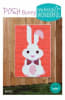 Posh Bunny Quilt Pattern from Sew Kind of Wonderful features an Easter bunny with big floppy ears on a red background. - Image 1 of 0