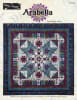 Arabella BOM pattern by Wing and A Prayer shows a large center medallion quilt with star blocks, and a variety of other quilt blocks in shades of ruby and aquamarine. - Image 1 of 0