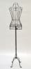Black female metal wire dress form standing on an antique metal base for retail garment display. - Image 1 of 0