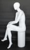 Female egghead mannequin in seated pose. Her legs are crossed with her hands on her lap. - Image 2 of 0
