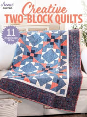 This shows the cover of Creative Two Block  Quilts from Annie's Quilting with 11 quilt patterns for 9.99