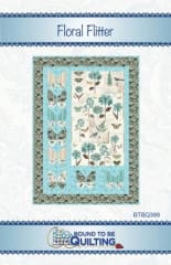 Floral Flitter Quilt Pattern by Bound to be Quilting shows a pretty botanical quilt made with a butterfly panel and butterflies for a sophisticated spring quilt for the modern neutral decor.