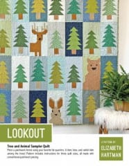 LOOKOUT Quilt Pattern  shows a quilt featuring  a bear, deer, and rabbit hiding among the  evergreen forest in a charming quilt design.