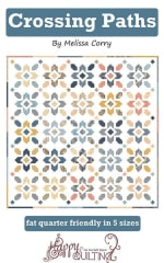 Crossing Paths Quilt Pattern by Melissa Corry shows a pretty quilt in scrappy colors with  pieced blocks in a straight set with small square cornerstones.