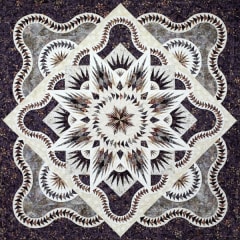 ARTIC STAR QUEEN Quilt Pattern by Judy Niemeyer shows a black and white center medallion quilt in dark batiks with intricate foundation piecing and an undulating border.