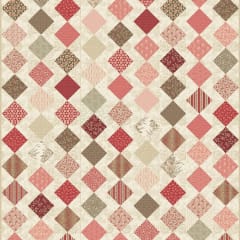 Blue Moon Quilt Pattern by Laundry Basket Quilts shows a traditional "zig zag quilt set in tones of cream, pink and brown.
