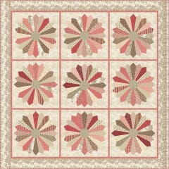 Dresden Plate Pattern by Laundry Basket Quilts shows a traditional dresden plate quilt set with sashing between the blocks, in tones of cream, pink and brown.