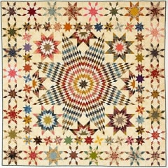 Let it Shine Quilt Pattern by Laundry Basket Quilts shows a modern, graphic star quilt in multi-color.