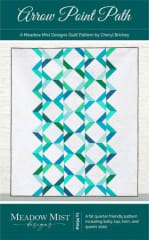 This quilt has a vertical design created by rows of half square triangles and is shown in shades of bright aqua and green on a white background.