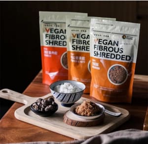 Vegan shredded seaweed fluff in a bowl with fresh herbs and a sprinkle of sesame seeds