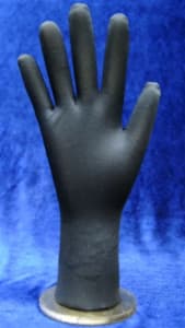 Flexible posable black fabric hand display with round metal base