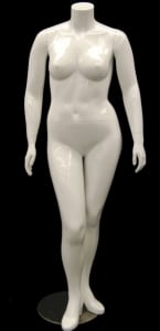 Plus size female fiberglass mannequin in a fleshtone finish standing on a round metal base with calf and foot support rods.