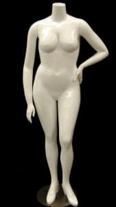 Plus size female fiberglass mannequin in a fleshtone finish standing on a round metal base with dual support rods.