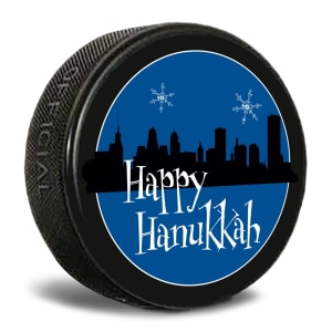 This is an official game puck printed with a slogan that says Happy Hanukkah. It fits into the puck box which is sold separately