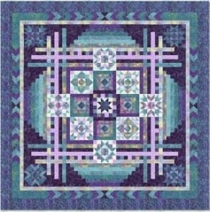 PARADISE Block of the Month Quilt Top Kit by Wing & A Prayer shows a blue & purple batik quilt designed by Wing & A Prayer with fabrics by Timeless Treasures in a very modern design.