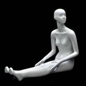 Seated abstract female mannequin in glossy white fiberglass with legs stretched out and no base required.