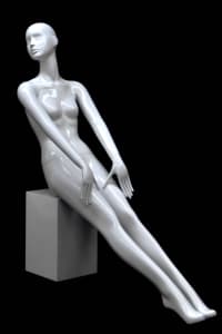 Seated abstract female mannequin in glossy white fiberglass leaning back with legs stretched out and no base required.