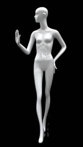 Abstract female mannequin in glossy white fiberglass with right hand raised and a round glass base.