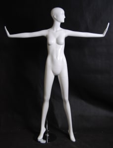 Tall abstract female mannequin in a high gloss white fiberglass finish standing on a stable metal base with ankle and foot rods.