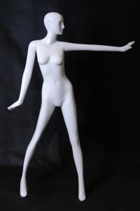 Tall standing female abstract mannequin in a glossy white fiberglass finish with a silver metal base.